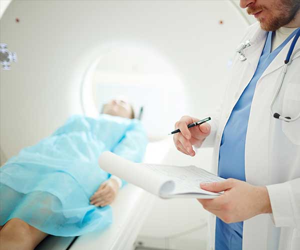 Doctor with patient using CT scan
